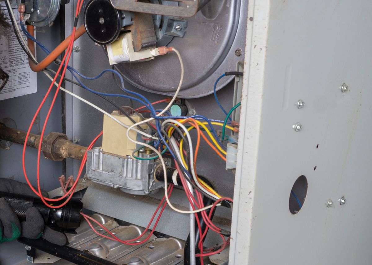 Technician Looking Over A Gas Furnace