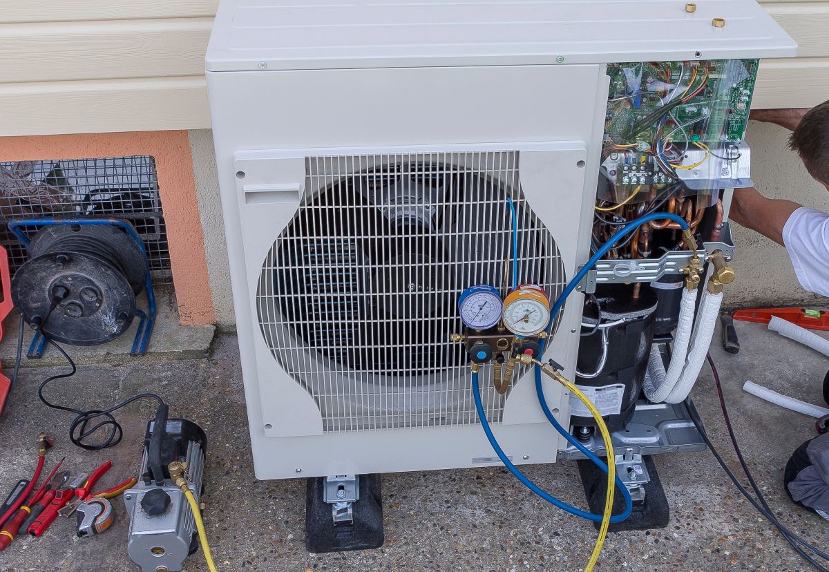 plumber at work installing a circulation heat pump